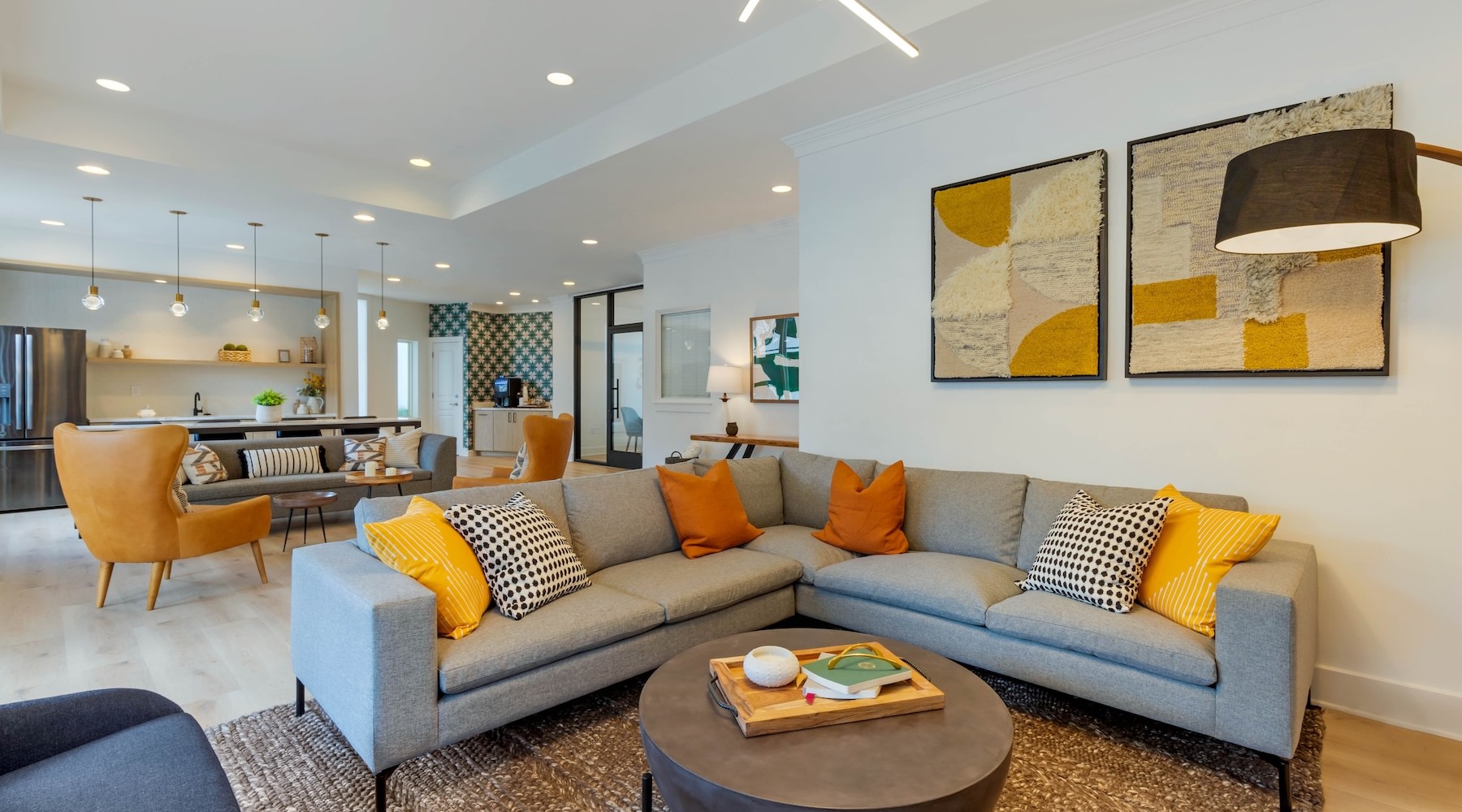 a clubhouse room with a large couch and a table