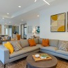 a clubhouse room with a large couch and a table
