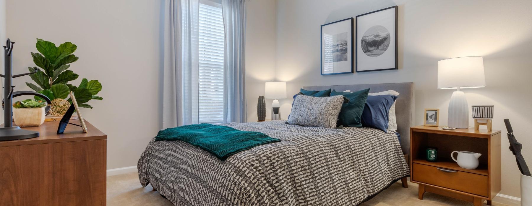 a bedroom with a bed and lamps