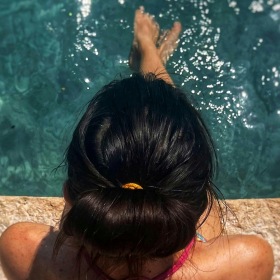 Sparkling swimming pool a girl sitting at a pool