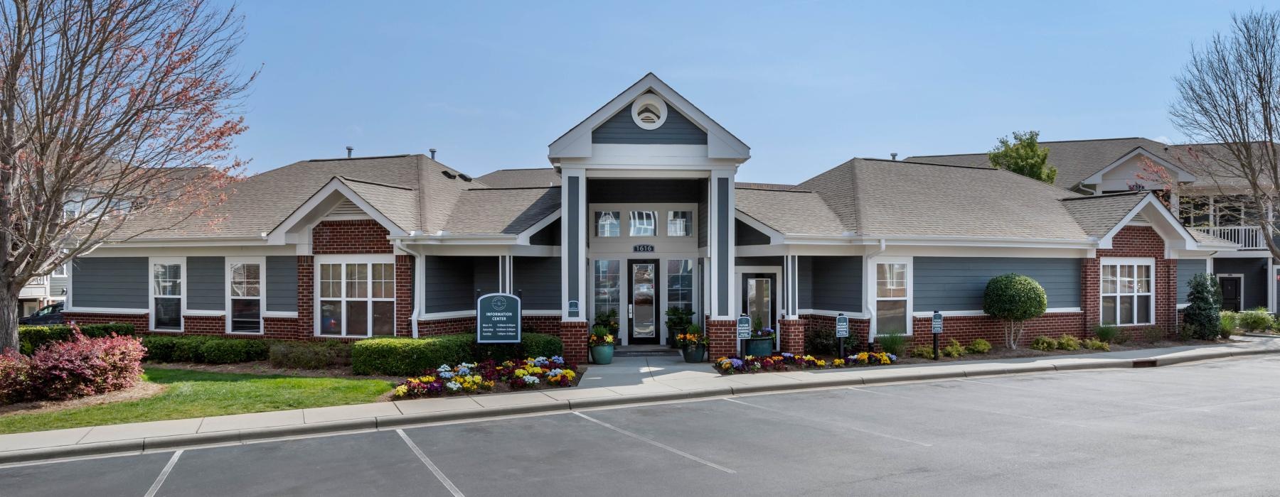 a leasing office building with a parking lot